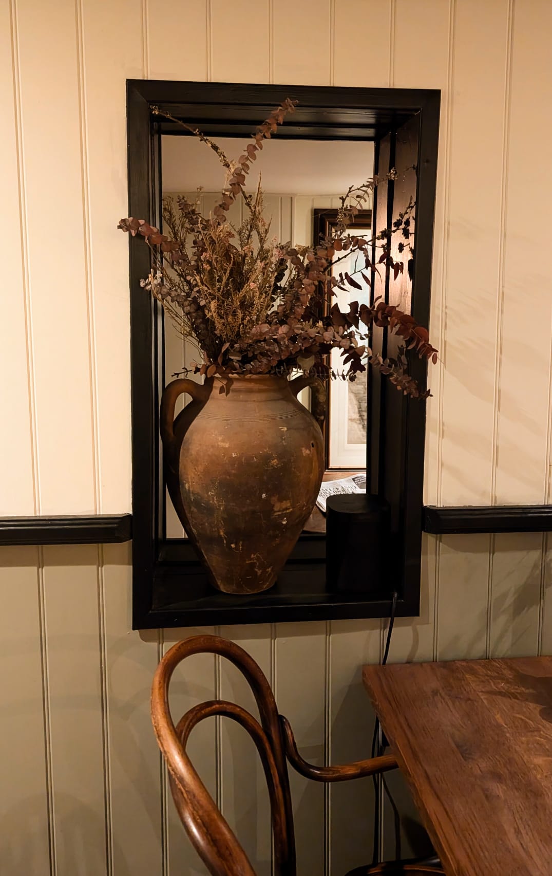 Rustic terracotta urn with dried foliage
